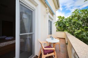 a small table and two chairs on a balcony at Apartments Veronika in Zadar