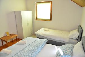 a small room with two beds and a mirror at Nia in Bihać +35 photos