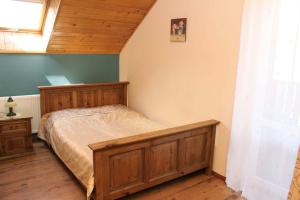 1 dormitorio con cama de madera en una habitación en Willa Górskie Retro, en Wisła