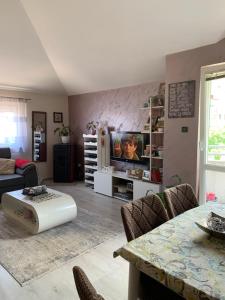 a living room with a couch and a tv and a table at Guest House Mudresa in Budva