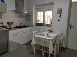 a kitchen with a table with a table cloth on it at Casita Lulu en pleno centro con wifi in Almería