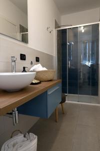 a bathroom with a sink and a glass shower at Domus Silvana Apartments in Ravenna