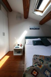 a bedroom with a white bed and a window at Domus Silvana Apartments in Ravenna