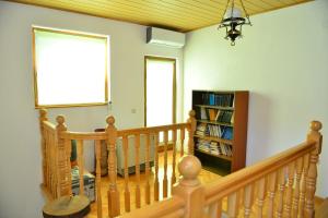 a room with a staircase with a window and a book shelf at Nia in Bihać