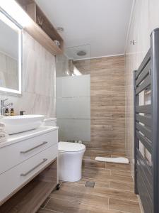 uma casa de banho com um lavatório branco e um WC. em Cozy studio in Dafnes near to Heraklion em Dhafnés
