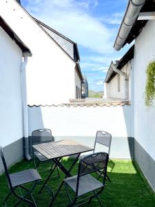 une table et des chaises sur le balcon d'une maison dans l'établissement WEINHOF Winningen Traumwohnung im „La Mosel•, à Winningen