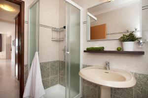 a bathroom with a sink and a shower at Apartments Agava in Rabac +51 photos