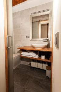 a bathroom with a sink and a mirror at Casa Nicole in Portell +28 photos