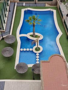 Swimmingpoolen hos eller tæt på Apartamento Olimpo Elite 8A