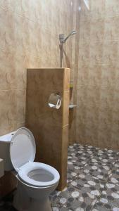 a bathroom with a toilet and a shower at Penida Dream Homestay and hostel in Nusa Penida +62 photos