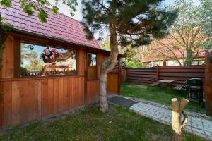 una casa con un árbol en el patio en Domek Pod Lasem, en Polanica-Zdrój