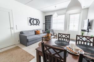 a living room with a couch and a table at Holiday In Lapland - LeviStar II 312 in Levi