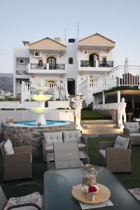 a view of a house with a table and chairs at Olympus Studios in Malia