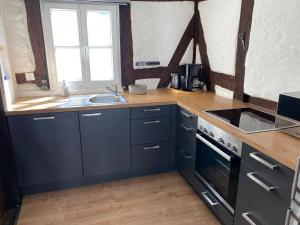 a kitchen with a sink and a stove at Kleines Bürgerhaus in Arnsberg