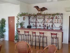a bar with a bird on top of it at Aetos Beach Bungalows in Karistos