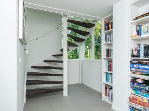 uma escada numa casa com estantes em Majestic holiday home in Kamperland with garden em Kamperland