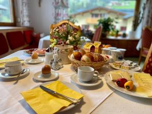 a table with a breakfast of eggs and bread at Haus Schrofenstein in Lech am Arlberg