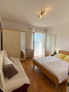 a bedroom with a large bed and a couch at Apartment Sea in Supetarska Draga