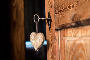 a heart shaped door knocker on a wooden door at La Gruba Relais in Gaby
