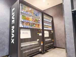 a vending machine with drinks and drinks in it at HOTEL LiVEMAX Sapporo Ekimae in Sapporo