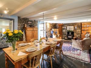 a dining room with a large wooden table and chairs at Tyddyn Bach in Newport Pembrokeshire