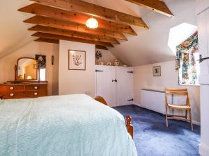 a bedroom with a bed and a desk and a window at Tyddyn Bach in Newport