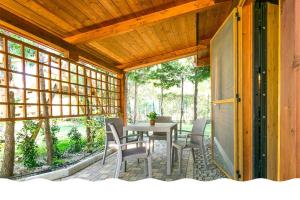 a screened in porch with a table and chairs at Freedom Village in Soverato Marina