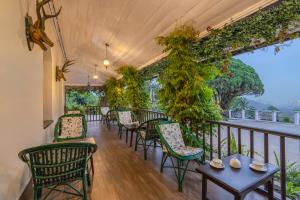 a row of chairs and tables on a balcony at Sterling Park Kalimpong in Kalimpong +38 photos