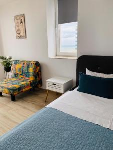 a bedroom with a bed and a couch at Sea View Studio in Constanţa