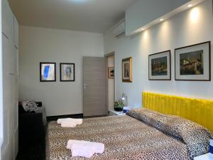 a bedroom with a large bed with a yellow headboard at House Sunflower by Holiday World in Arenzano