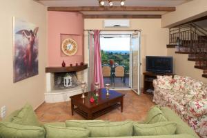 a living room with a couch and a table at Villa Maria Kefalonia in Kaligata