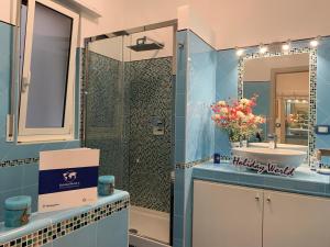 a blue bathroom with a sink and a shower at House Sunflower by Holiday World in Arenzano +16 photos