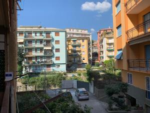 a car parked in a parking lot in front of buildings at House Sunflower by Holiday World in Arenzano