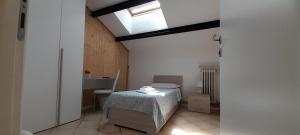 a small bedroom with a bed and a skylight at Last Minute Ferrara in Ferrara