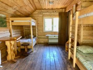 a cabin with two bunk beds and a desk at Аляска in Oryavchyk