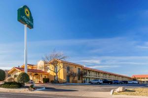 a sign for a hotel in front of a parking lot at La Quinta Inn by Wyndham Odessa in Odessa