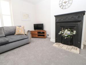 a living room with a couch and a fireplace at Toll House in Corbridge