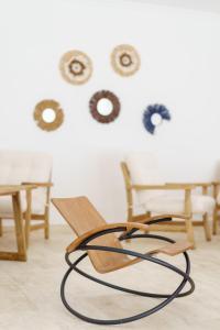 a wooden chair in a room with wooden chairs at Costa Maya Bodrum in Bodrum City