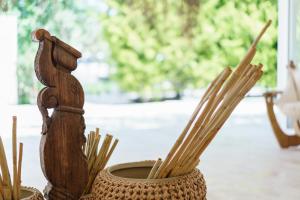 a vase filled with bamboo sticks next to a table at Costa Maya Bodrum in Bodrum City