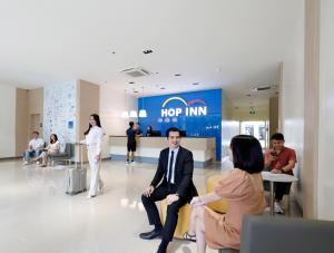 a group of people sitting in a lobby at Hop Inn Ortigas Center Manila in Manila