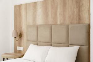 a bedroom with a bed with a large wooden headboard at Costa Maya Bodrum in Bodrum City