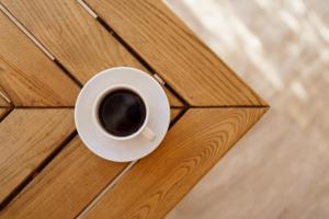 a cup of coffee sitting on a wooden table at Costa Maya Bodrum in Bodrum City