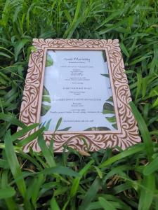 a framed menu sitting in the grass at Siri Beach Lodge in Nungwi