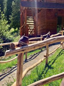 a wooden fence in front of a log cabin at Аляска in Oryavchyk