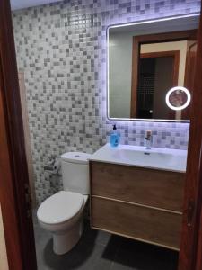 RoquetasにあるCasa Mar Roquetesのトイレ、洗面台、鏡を備えたバスルーム