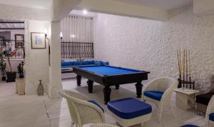 a pool table in a living room with chairs at CHARM BEACH HOTEL in Akyarlar