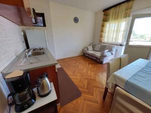 a kitchen with a sink and a couch in a room at Apartments in Porat/Insel Krk 13155 in Porat