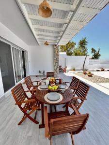 a dining room with a wooden table and chairs at Vaso Sea Villa in Ialyssos