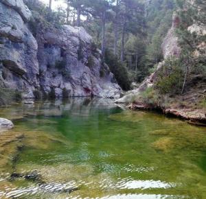 a river with green water in a rocky canyon at Casa Mar Roquetes in Roquetas