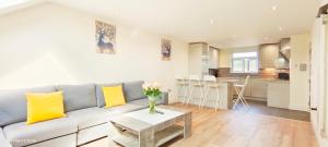 a living room with a couch and a table at Top Floor Flat 5 Northwood in Northwood